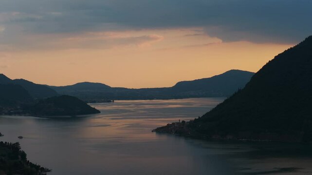 Warm sunset colors reflecting on the calm waters of Lake Idro in the province of Brescia, Italy