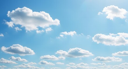 Fototapeta premium A serene expanse of blue sky dotted with fluffy white clouds, suggesting a clear and peaceful day. 