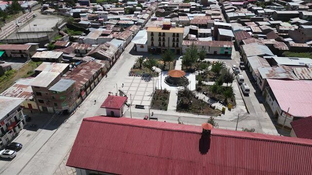 Low aerial approaches plaza in charming mtn town, Cajatambo Peru