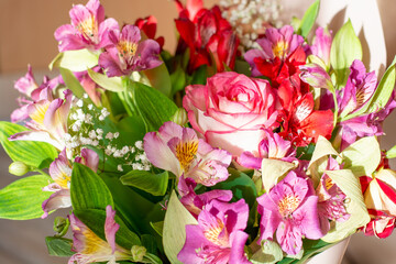 colorful, bright bouquet illuminated by the rays of the sun, greeting card. High quality photo