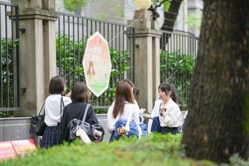 In early June in Pudong, Shanghai, seven Japanese high school girls in summer uniforms walk...