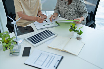 Office group working on green power solution for achieving carbon neutrality in clean energy...