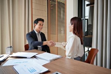 Team leader confirming job agreement with handshake during new employment contract meeting