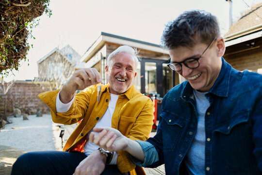 Father and son celebrating new home ownership outdoors