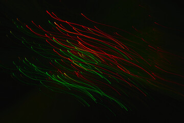 Abstract image of red and green light trails in motion captured with long exposure