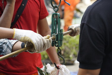 A team of workers is busy weighing goods in the warehouse