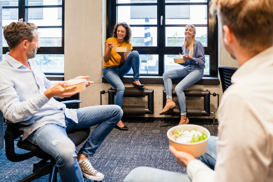 Employees having lunch break at coworking office