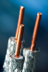 Coaxial cable with exposed shielding and central conductor, on a dark background, close-up view