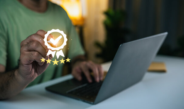 Person using laptop with digital checkmark badge symbolizing quality assurance and customer satisfaction in a modern workspace environment