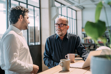Engineers discussing strategy and growth in an office setting