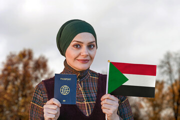 Muslim Woman Holding Passport and Flag of Sudan
