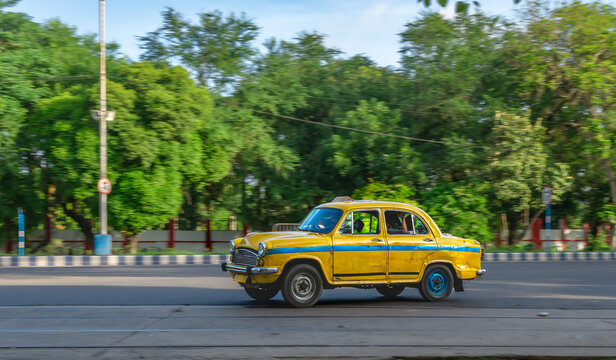 West Bengal, India. May 26,2025. Motion Blue Image of a Yellow Taxi in Kolkata City.