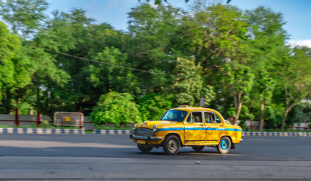 West Bengal, India. May 26,2025. Motion Blue Image of a Yellow Taxi in Kolkata City.
