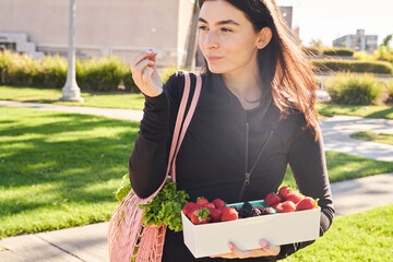 Woman buying fruit and food at the farmers market