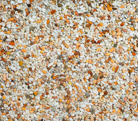 Top view of different earth tones and shapes of small  natural sstones or use as a background texture.