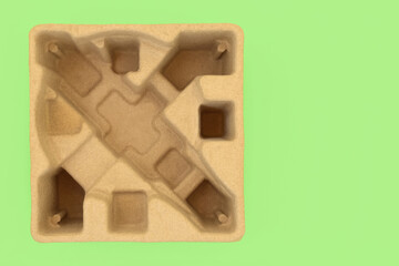 Eco friendly cardboard delivery box insert on green background. Biodegradable compostable product...