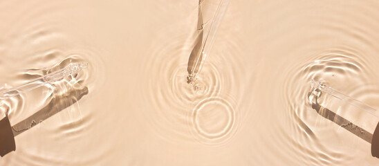 pipette serum in water on beige background ripples water drops natural sunlight