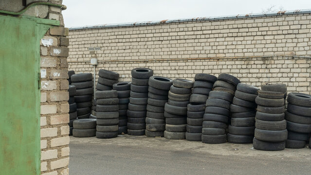 Storage of discarded old car tires outdoors, showcasing a pile of used tires ready for recycling. Highlighting environmental concerns and rubber waste management