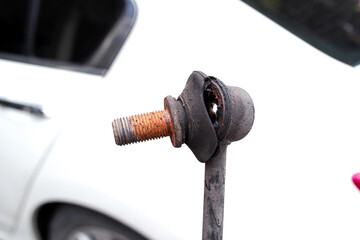 Stabilizer bar link worn out or stabilizer ball joint degraded, A close-up of a rusty, worn anti-roll bar link