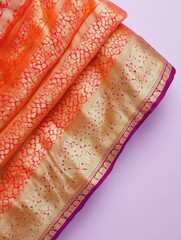 Elegant traditional indian silk saree with exquisite gold pattern on purple hue fabric
