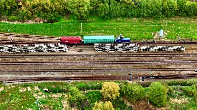 Beautiful aerial view of goods train in Joni&scaron;kis travelling through farmland