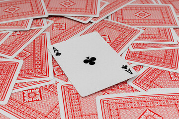 Ace of clubs revealed among red playing cards