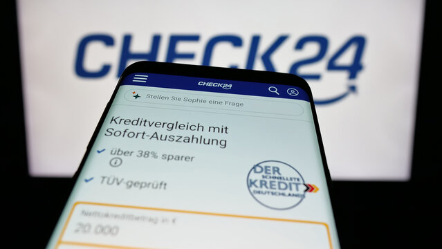 Stuttgart, Germany - 05-25-2025: Mobile phone with website of German price comparison company Check24 GmbH on screen in front of logo. Focus on top-left of phone display.