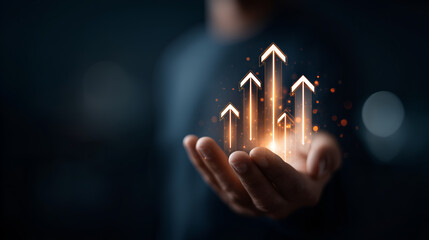 a hand holding upward arrows. This conceptual image represents growth, progress, and the achievement of goals