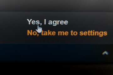 Close-up of screen a cookie consent prompt on a screen with Yes, I agree and No, take me to settings options