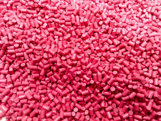 Red polymer granules, red masterbatch granules, cold cutting material type, isolated on white background for product catalog design of plastic manufacturing industry company profile