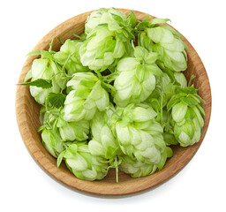 Hop cones in wooden bowl isolated on white background. Beer brewing ingredients. Beer brewery...