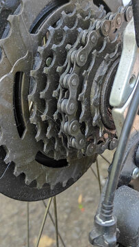 Macro of multi-speed bicycle cassette coated with grease and dirt, capturing rugged authenticity for repair guides, mechanical blogs, and sports equipment catalogues