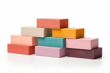 Obraz premium Colorful blocks stacked artistically on a white surface in an indoor setting
