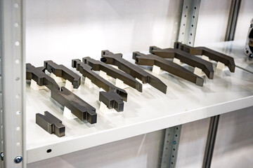 Precision metal cutting tools and dies arranged in industrial workshop. CNC machining equipment...