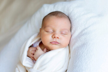 Sweet beautiful baby girl, sleeping in bed with teddy bear, pure colors, infant sleeping 