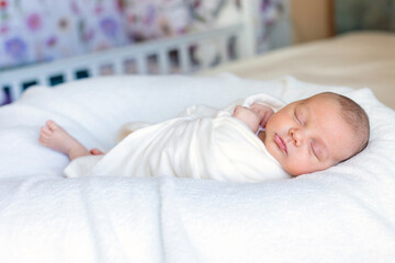 Sweet beautiful baby girl, sleeping in bed with teddy bear, pure colors, infant sleeping 