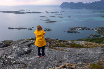 Fototapeta premium Family with children and pet, hiking Sukkertoppen trail on Senja island, Norway