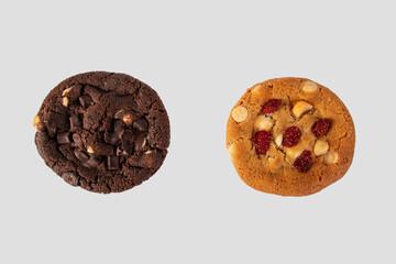 Vanilla cookies topped with nuts and strawberries ฟืก A large chocolate cookie topped with chocolate chips on a white background