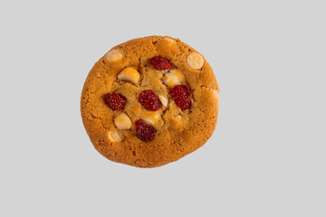 Vanilla cookies topped with nuts and strawberries on a white background