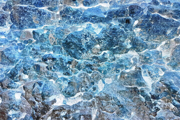 Distressed Grungy Blue Overlay Dry Coral Rock Wall Texture from Tropical Coastline with Natural Holes