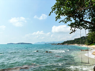 Wooden Swing Hanging Over the Sea with Blue Sky and Clouds in the Background at Hanuman Bay, Koh Samui, Thailand