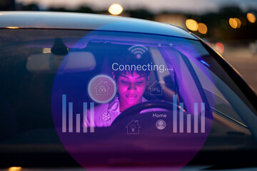 Businesswoman sitting in car with digital display on windshield