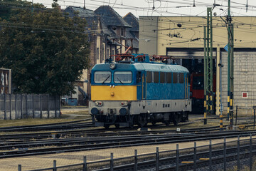 Electric locomotive near railway depot
