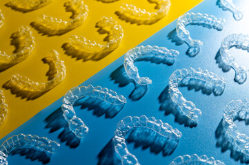 Braces, invisible aligners. Blue with yellow background. Prevention and treatment of gums and teeth, modern jaw straightening