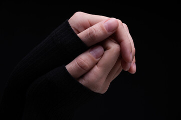 Female hands on a black background. Concept of tenderness and self-care.