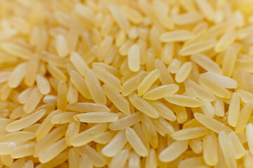 White long grain rice background texture. Macro shot of a handful of rice