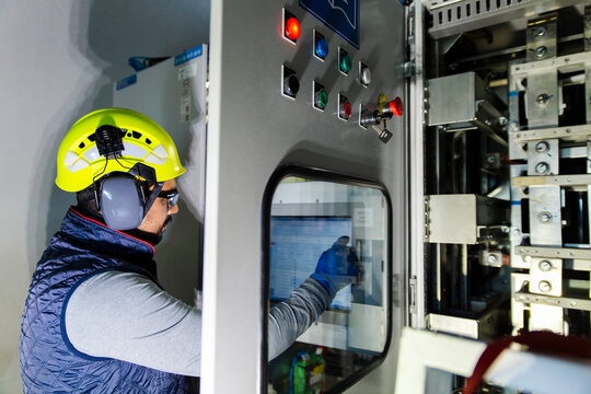 Engineer operating medium voltage cell in wind turbine tower for maintenance