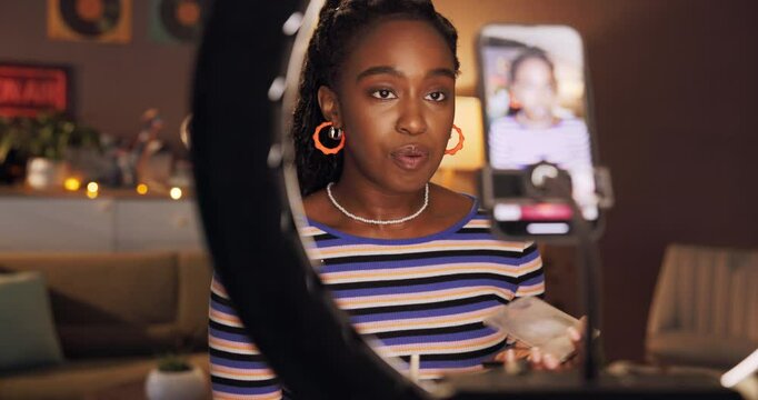 Live streaming, ring light and makeup with black woman in home for influencer, promotion or brand. Virtual tutorial, content creator and beauty artist review with person and phone for vlog broadcast