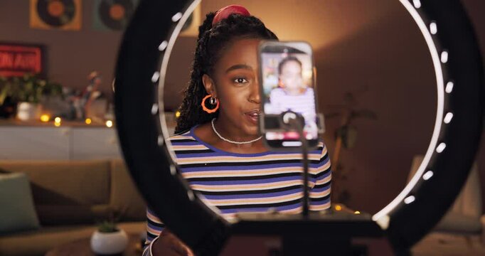 Makeup, influencer and ring light with black woman and phone for cosmetics promotion, brand and vlog. Beauty sponsorship, follower engagement and content creator with person in home for recording