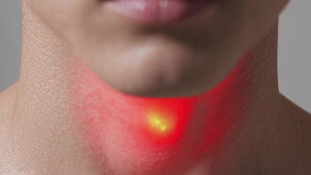 Close up of a male neck highlighting the thyroid gland with a red spot, visualizing pain and inflammation, possibly indicating a thyroid issue